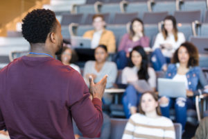 Man speaking to students in a lecture